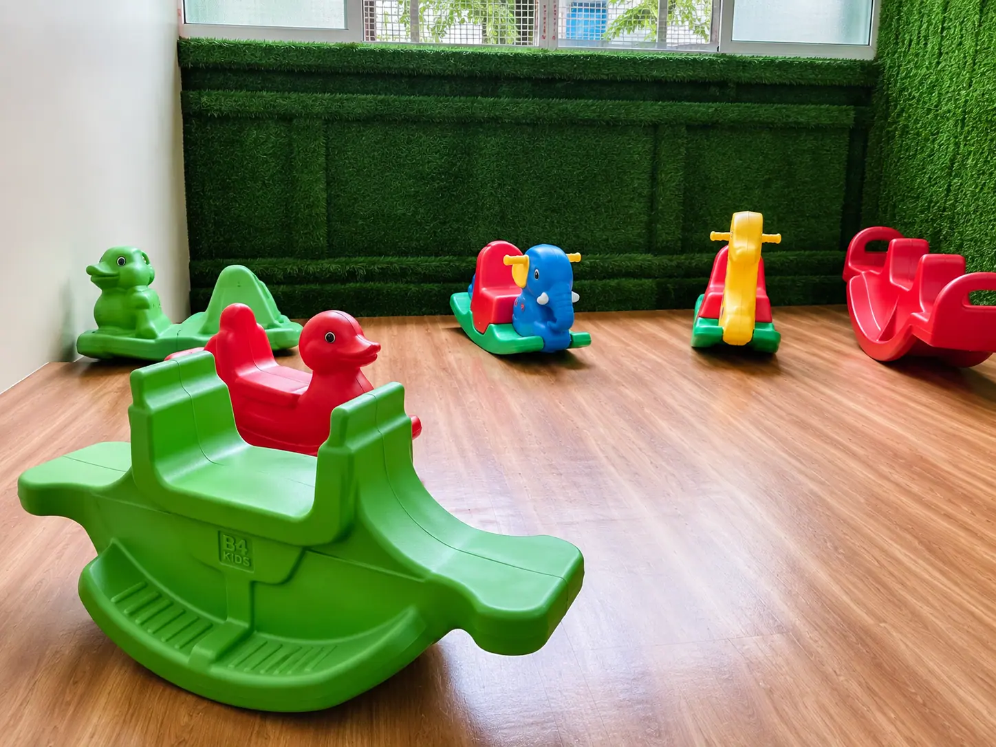 Playgroup toddlers exploring soft rocking toys