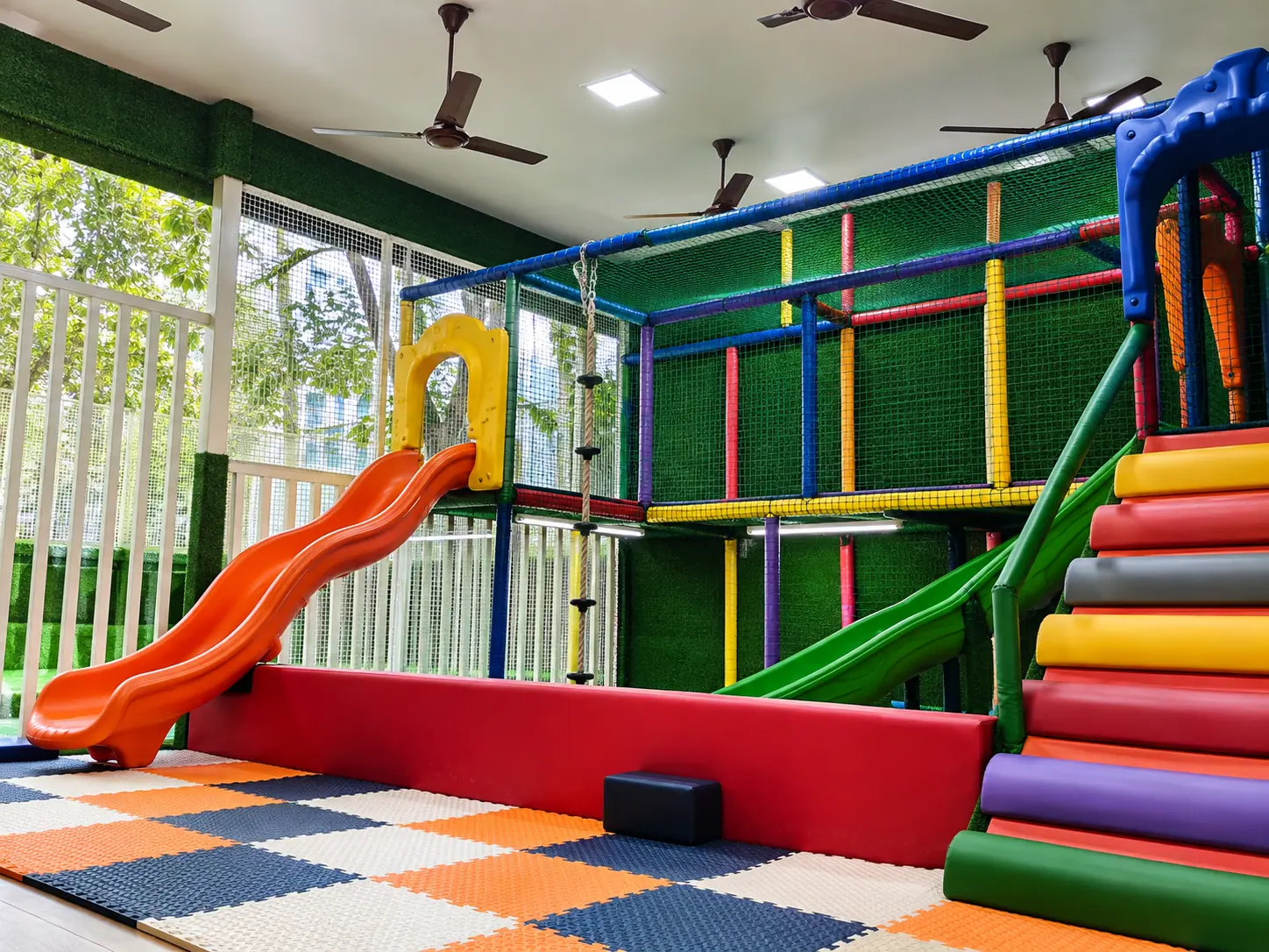 Nursery children on the indoor soft-play climbing structure