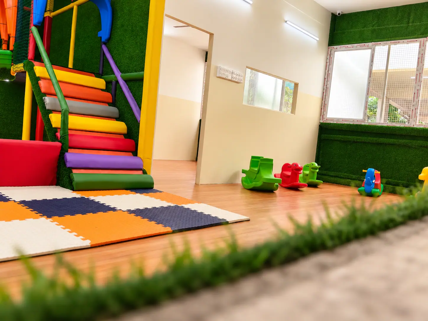 LKG children using the padded soft-play staircase